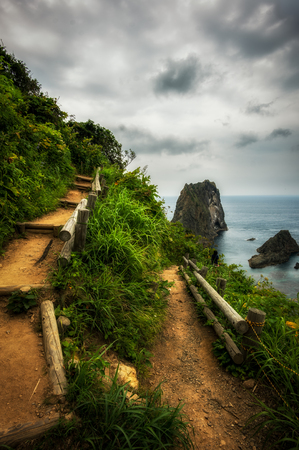 Shakotan coast with stairs leading up to the sea under overcast.の写真素材