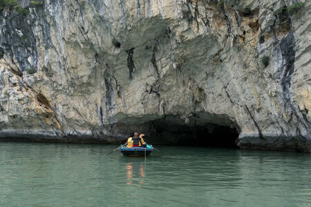 Tourists riding through luon cave in Halong bay.の写真素材