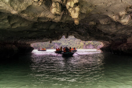 Tourists riding through luon cave in Halong bay.の写真素材