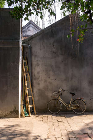 Ngoc Son Temple wall with a bike and ladderの写真素材