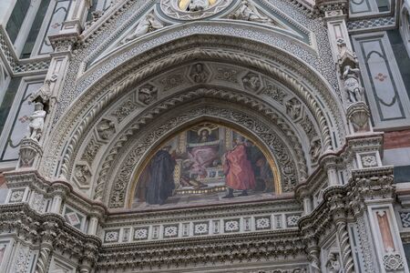 Duomo main entrance painting with elegant florentine architecture.の写真素材