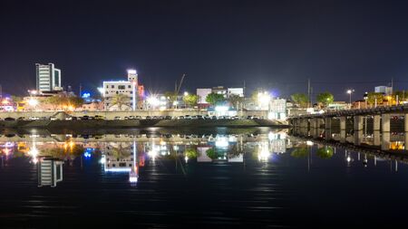 Gangneung City and market area reflecting on the namcheon river taken at nightの写真素材
