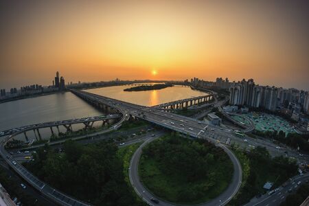 Mapo bridge view from top of a building, sunset shining on the traffic during rushhour in seoul, south koreaの写真素材