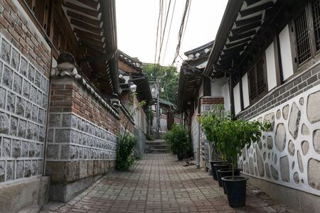 Traditional Bukchon Hanok village alleyway with brick houses and narrow streets lined with traditional korean architecture walls. Taken in Seoul, South Koreaの写真素材