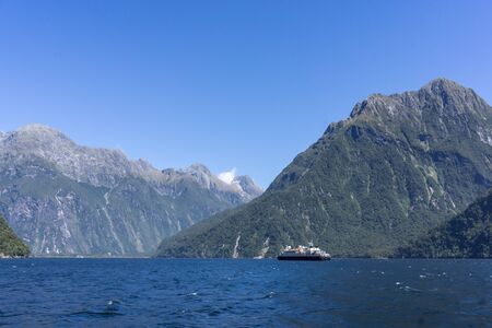 Milford sound taken from the cruise boat. Various waterfalls along the valley. Taken in New Zealand during summer.の写真素材