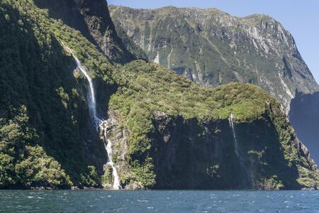 Milford sound taken from the cruise boat. Various waterfalls along the valley. Taken in New Zealand during summer.の写真素材