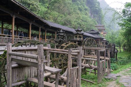 gallery of watermills in front of huanglong cave entrance area in zhangjiajie, chinaの写真素材