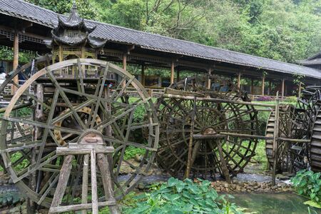gallery of watermills in front of huanglong cave entrance area in zhangjiajie, chinaの写真素材