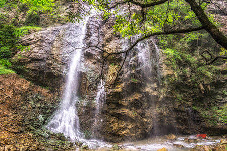 zhangjiajie grand canyon waterfall view with lush forest and narrow creek. Daxiagu, Chinaの写真素材