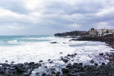 hagwe-aewall coastal road view with waves hitting the coast side. Jeju Island, South Koreaの写真素材