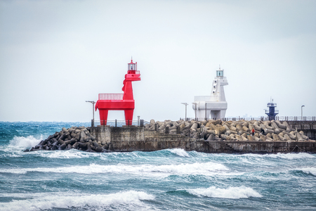 Iho Tewoo Beach two horse shaped lighthouses. Jeju Island, South Koreaの写真素材