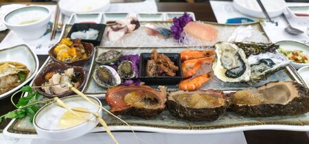 raw seafood platter in jeju island, south korea. Ginseng, sea abalone, shrimp, oysters, and sea squirt.の写真素材
