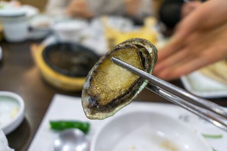 close up of cooked roasted sea abalone. Jeju island, south koreaの写真素材