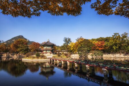 hyangwonjeong pavilion during autumn foliage season gyeongbok palace in seoul, south koreaの写真素材