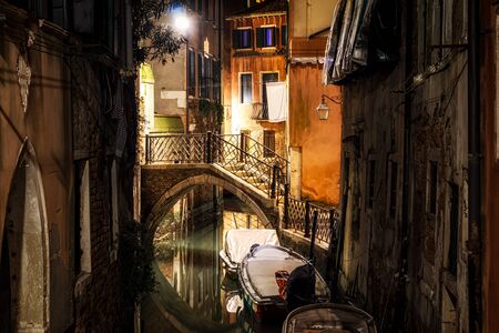 Venice Canal scene with a small bridge at night.の写真素材