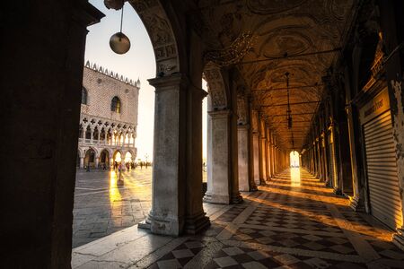 Sunlight through columns of saint mark square plaza in Venice, Italyの写真素材
