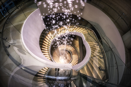 a spiral staircase leading down to the lobby.の写真素材