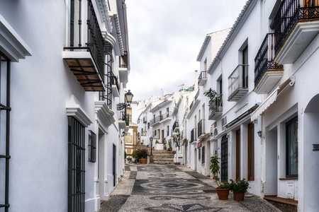 White colored village of Frigiliana in Spain. Narrow streets and alleyways surrounded by white colored houses.の写真素材