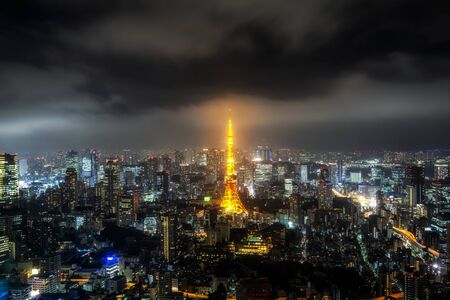 tokyo tower illumianted taken at night with the surrounding city view. Taken from Roppongi hills sky deck in tokyo, japan.のeditorial素材