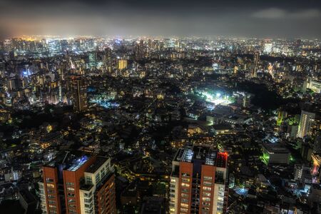 tokyo city night view with city lights illuminating the night sky above. Taken from Roppongi hills sky deck in tokyo, japanのeditorial素材