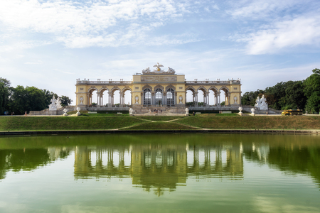 the view of gloriette reflecting on the small pond water in the front taken in the schonbrunn palace gardens in vienna, austria.のeditorial素材