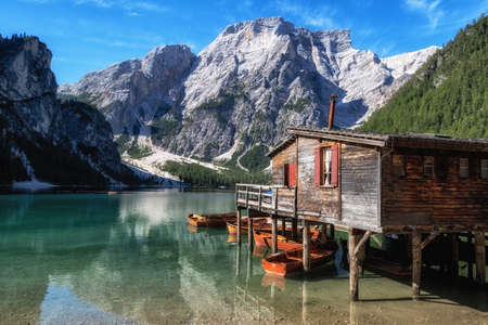 Lago di Braies a famous landmark in Dolomites Italy in South Tyrol with a wooden hut. A small lake...