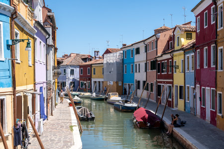 Brightly multi coloured houses over the canal in Burano, Italy. Famous island nearby Venice, Italy. Taken on July 14th 2022のeditorial素材