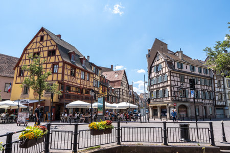 Colmar old town street with tourists walking about. Half timbered colorful german houses taken in Colmar, France. Taken on June 11 2023のeditorial素材
