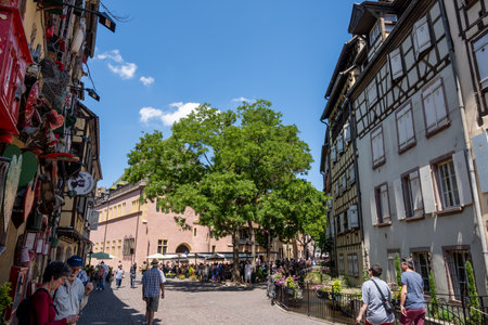 Colmar old town street with tourists walking about. Half timbered colorful german houses taken in Colmar, France. Taken on June 11 2023のeditorial素材