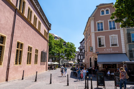 Colmar old town street with tourists walking about. Half timbered colorful german houses taken in Colmar, France. Taken on June 11 2023のeditorial素材