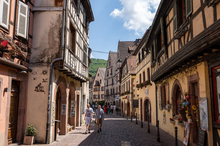 Small colorful german half timbered houses in Kaysersberg along the main street. Taken in Kaysersberg, France. Taken on June 11 2023のeditorial素材