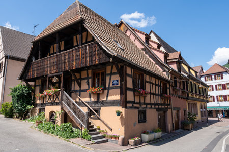 Small colorful german half timbered houses in Kaysersberg along the main street. Taken in Kaysersberg, France. Taken on June 11 2023のeditorial素材