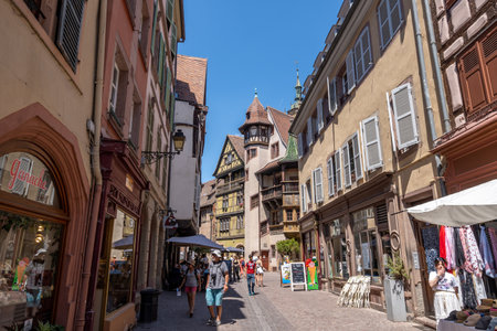 Colmar old town street with tourists walking about. Half timbered colorful german houses taken in Colmar, France. Taken on June 11 2023のeditorial素材