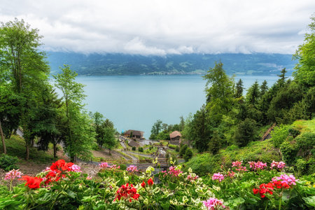Saint beatus cave entrance and nearby waterfall. Taken in Interlaken, Switzerlandの写真素材