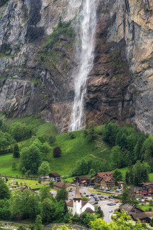 View of Lauterbrunnen village and Staubbach Waterfall. Famous tourist attraction in Bernese Oberland, Switzerlandの写真素材