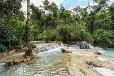 Various views of turquoise colored waterpools and waterfalls surrounded by lush forest. Taken in Kuang Si Waterfalls in Luang Prabang, Laosの写真素材
