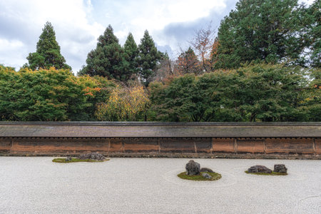 Zen rock garden in Ryoanji temple taken during autumn foliage season. Famous Temple in Kyoto, Japanの写真素材