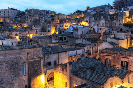 Sunrise View of Sassi di Matera. Interconnected vast areas of cave dwellings homes along narrow streets. Famous iconic attraction in Matera, Italyの写真素材