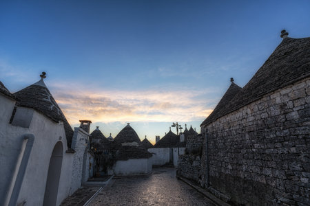 Empty streets of Trulli houses in Alberobello in the morning. Famous iconic conical rooftop houses in Southern Italyの写真素材
