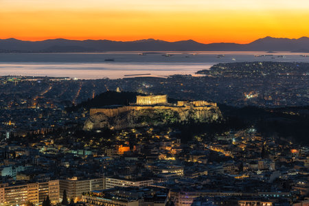 Sunset light over Athens and acropolis in the distance. Famous sunset cityscape viewpoint taken from...