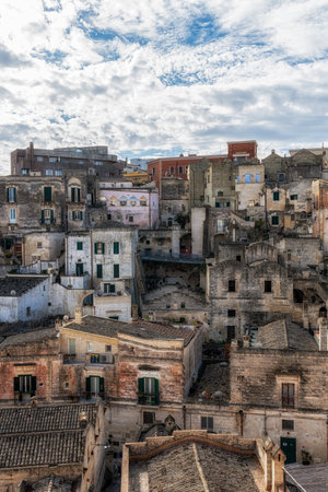 View of Sassi di Matera. Interconnected vast areas of cave dwellings homes along narrow streets. Famous iconic attraction in Matera, Italyの写真素材