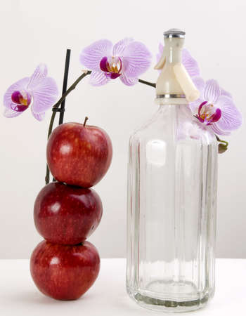 Orchids, apples and soda isolated on white and grayの写真素材