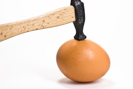 egg and hammer on white backgroundの写真素材