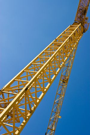 yellow crane against blue skyの写真素材