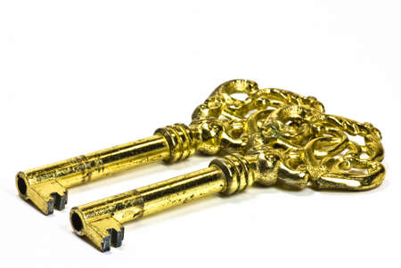vintage golden keys on white backgroundの写真素材