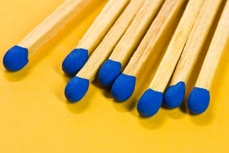 blue matches on yellow backgroundの写真素材