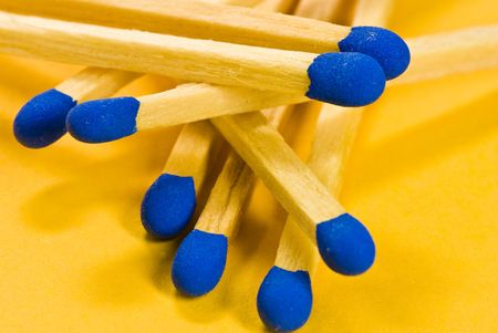 blue matches on yellow backgroundの写真素材