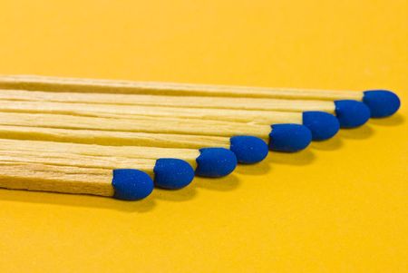 blue matches on yellow backgroundの写真素材