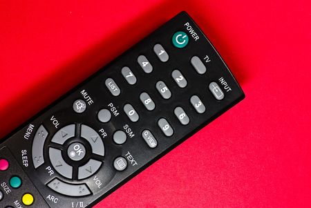 remote control on red backgroundの写真素材