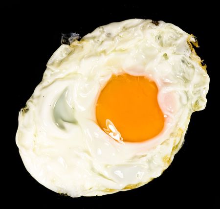 fried egg on black backgroundの写真素材
